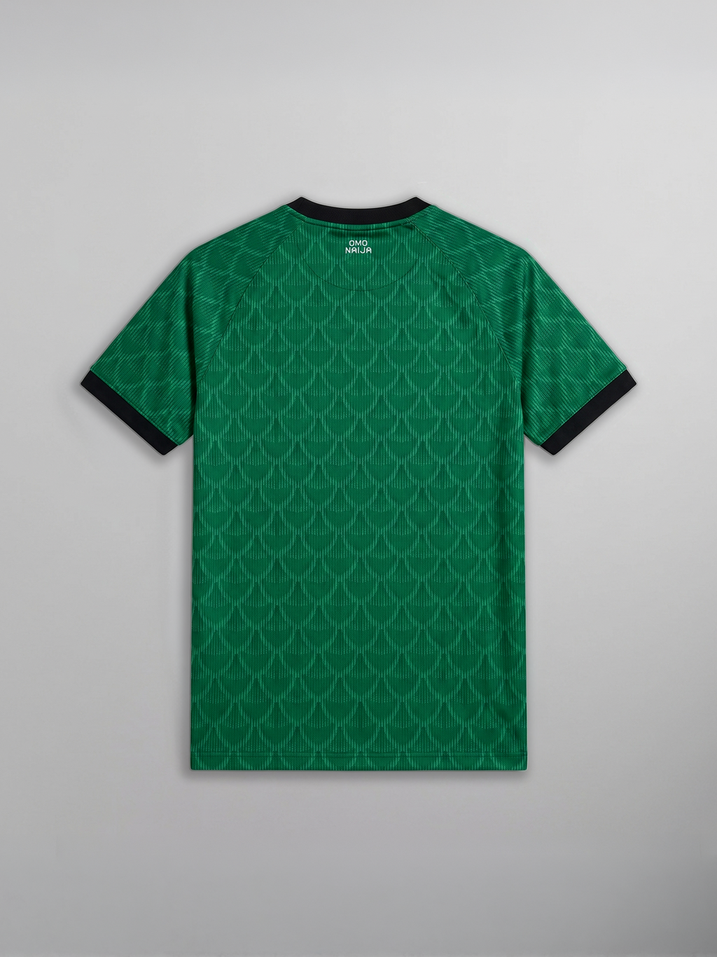 Green patterned t-shirt with black trim on a gray background